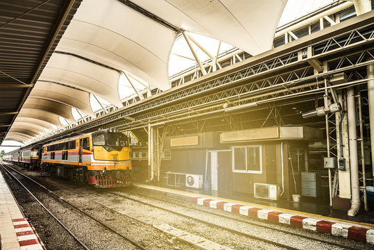 Classicistical train station and train at the railway station at sunlight.