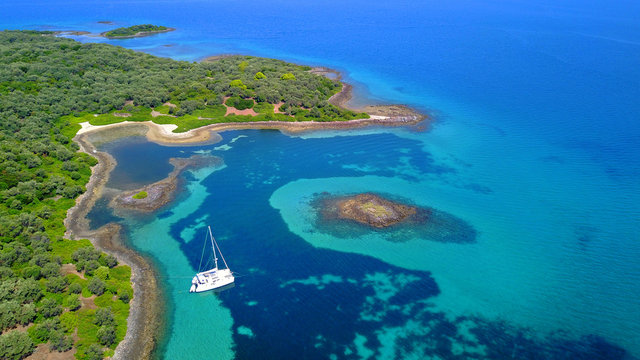 Aerial drone photo of Monolia island exotic beach with sapphire and turquoise clear waters, called the "Seychelles" of Greece, Lihadonisia island complex, North Evoia gulf, Greece