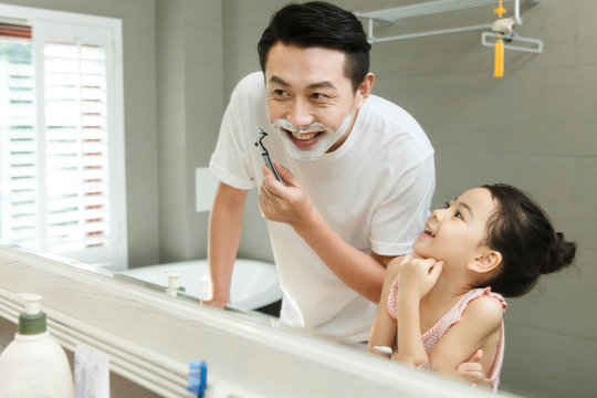 Father and daughter in bathroom