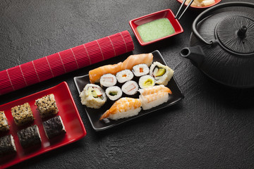 Sushi set on black table background