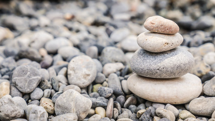 Small tower made of pebbles on a rocky beach
