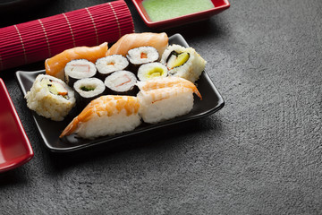 Sushi set on black table background