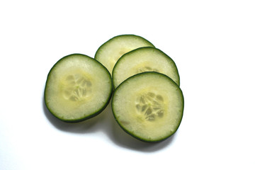 Closeup of cucumber slices on a white background