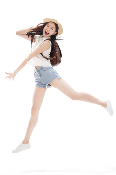 Portrait of young woman jumping in air