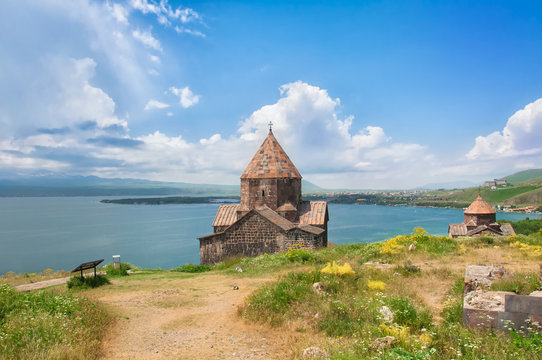 Sevanavank is a monastic complex located on a peninsula at the northwestern shore of Lake Sevan in the Gegharkunik Province of Armenia. View, on Lake Sevan skyline and blue sky with clouds.