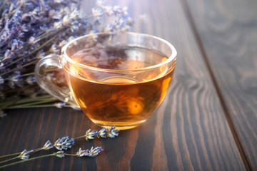 Cup of lavender tea and lavender flowers.