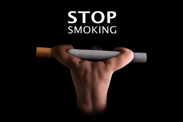 The fight against nicotine addiction. A man carries a cigarette on his shoulders. The symbol of dependence and struggle with smoking.