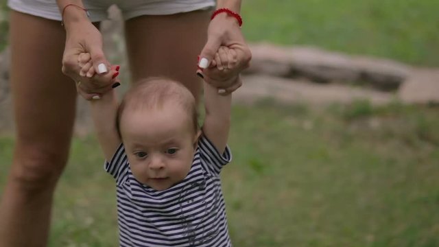 Mom plays with a small child close-up
