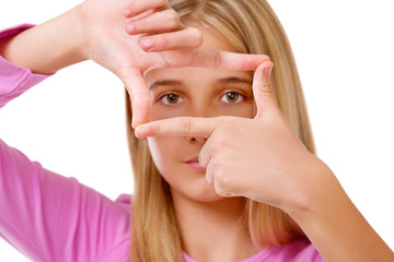 Picture of lovely young girl creating a frame with fingers.Isolated