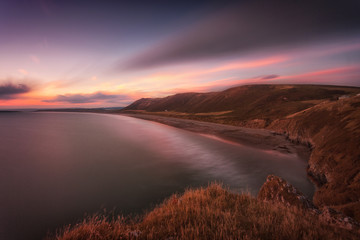 Sunset at Rhossili Bay at the far tip of the Gower peninsula, South Wales, UK