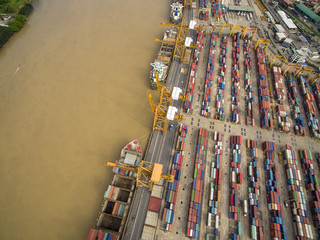 Aerial View Above the Bangkok Dockyard by the Chao Phraya River with Cargo Ships Waiting to be...