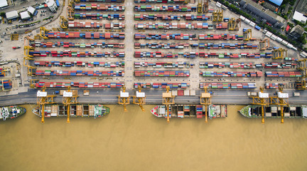 Aerial View Above the Bangkok Dockyard by the Chao Phraya River with Cargo Ships Waiting to be...