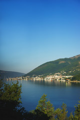 Fototapeta na wymiar View of Boko Kotorska bay in Montenegro on a hot summer day. Vacation on the beach, the morning landscape in the bay.