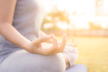 Close up hands woman do yoga,Asian girl doing yoga in garden with morning light