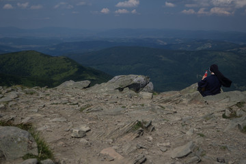 nun relaxes in the mountains