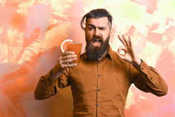 Brutal caucasian hipster holding tropical alcoholic fresh cocktail