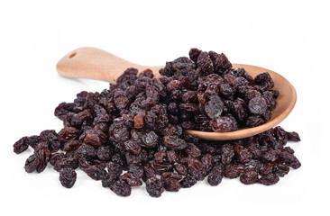 Dried Grapes into a spoon isolated in white background