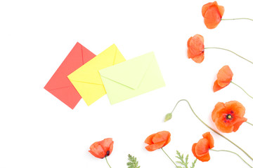 Three envelopes and red poppies on white background.