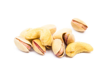 Pile of roasted pistachios and cashew isolated on white background