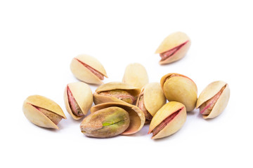 Pile of roasted pistachios isolated on white background