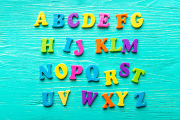Multiple colored letters on wooden table