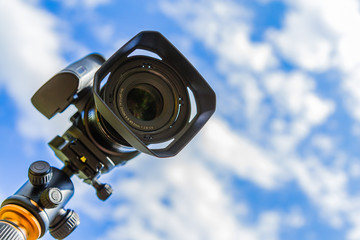 Digital camera closeup on a background of sky and clouds. Shooting on location and nature.