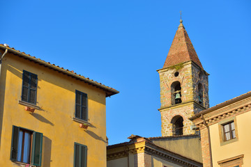 Close-up of colorful buildings, bell tower and rooftops in a blue sunny day at Umbertide, a gracious little town near Perugia, Italy