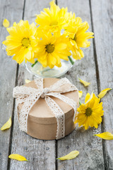 Hand crafted gift and yellow daisies