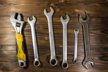 Old wrench tools on wooden background