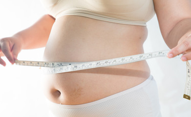 big belly of a fat man and measuring tape isolated on white