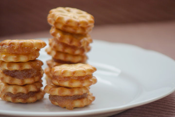 Fototapeta na wymiar Stacked pineapple biscuits on white plate