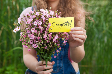 Congrats - beautiful woman with card and bouquet of pink flowers