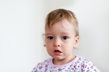 2 years old girl child is doing facial expressions
