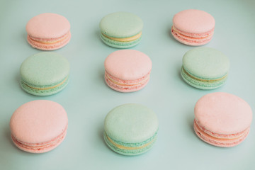 Fototapeta na wymiar Sweet green and pink macaroons on blue background