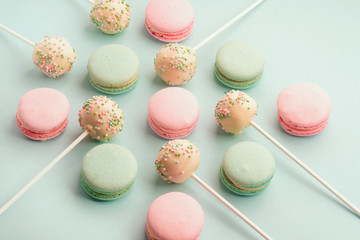 Sweet colorful macaroons with cake pops or cake crumbs with icing on sticks