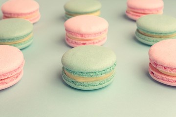 Fototapeta na wymiar Assortment of sweet pastel color macaroons in rows