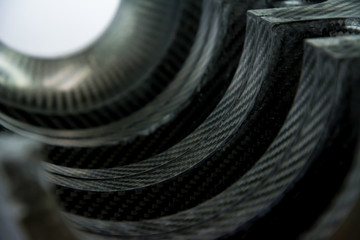 Black carbon fiber composite raw material close up background