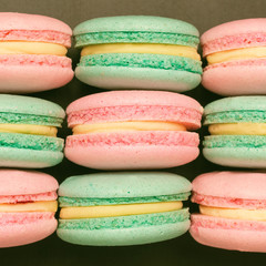Top view of sweet colorful macaroons on black background. Flat lay
