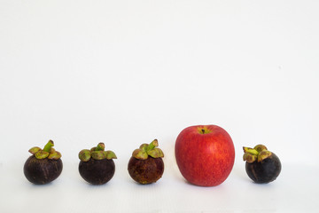 Group of fruit mangosteen and apple in differentiation concept
