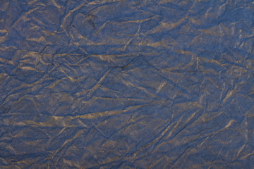 Crumpled paper texture blue color with gold spray