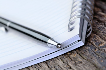 Empty notepad with pen on table