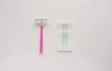 Tool, instrument for hair depilation: razor and wax strips on a white background. Top. Close-up. Stock photo