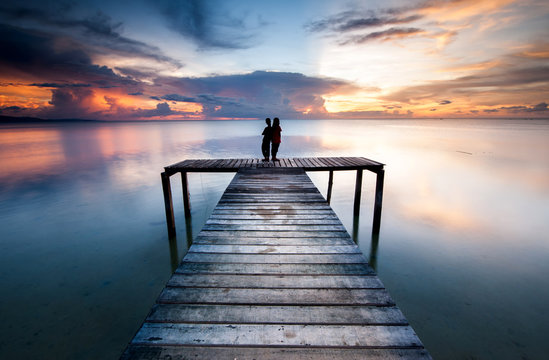 View of beautiful sunset with wooden jetty. image contain soft focus due to long expose.
