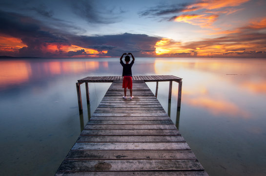 View of beautiful sunset with wooden jetty. image contain soft focus due to long expose.