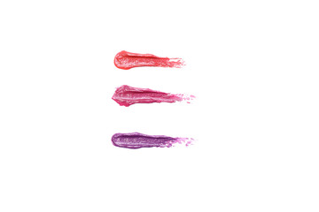 Samples of moisturizing lipstick on white background