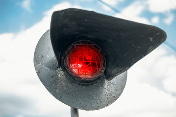 Old railway red lantern at the intersection of the road