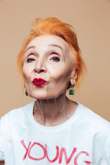 Mature redhead fashion woman blowing kisses.
