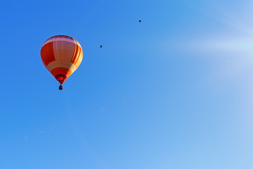 Colorful hot air balloon flying on a beautiful summer morning.