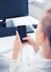 businesswoman with smartphone in office
