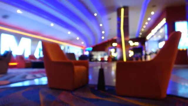 Time Lapse. Cinema complex lounge interior and people moving, abstract blur background